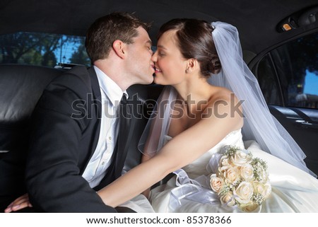 Newlywed couple kissing each other