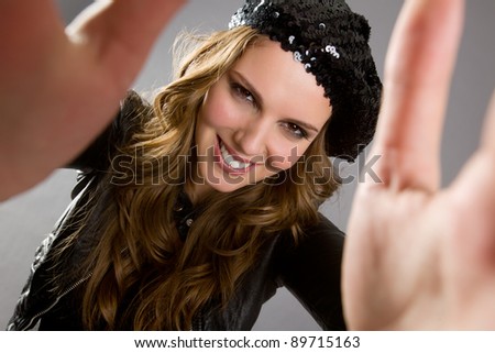 Portrait of an attractive brunette woman reaching out to the viewer