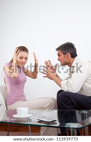 Portrait of an angry couple arguing.