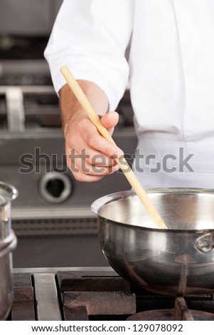 Cropped image of male chef preparing food in kitchen