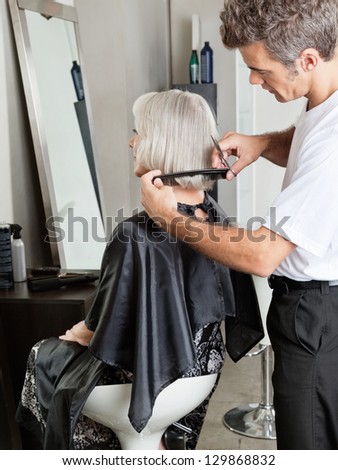 Senior woman getting her hair cut in beauty parlor