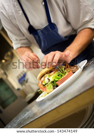 Detail of a chef preparing a gourmet burger