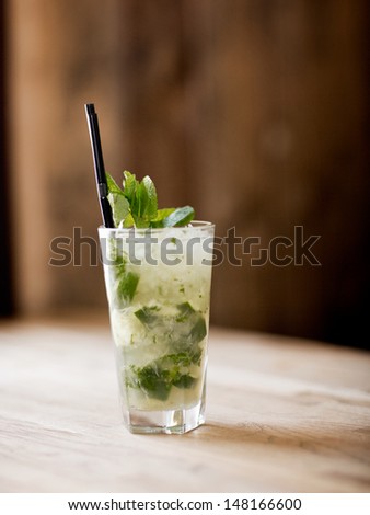 A mojito cocktail in a rustic restaurant on a table