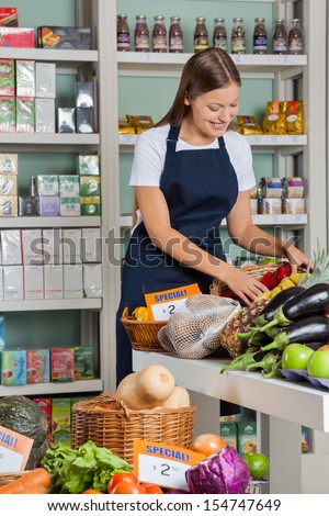 Beautiful young saleswoman working in supermarket