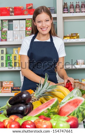 Portrait of happy saleswoman working at supermarket