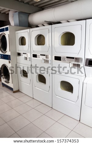 Row of self-service clothes dryers in laundry