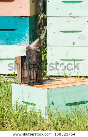 Closeup of bee smoker on crate at apiary