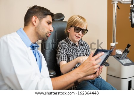 Young boy taking stereoacuity test in optometrist office