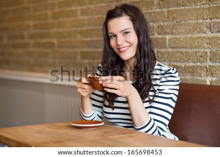 Portrait of attractive woman sitting in coffee shop