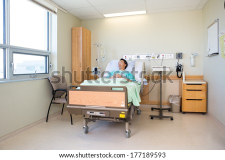 Thoughtful mature male patient lying on bed in hospital