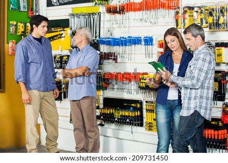 Male and female customers in hardware store