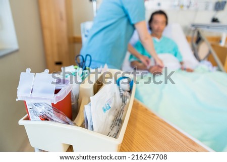 Close up of IV cart with nurse and patient in background