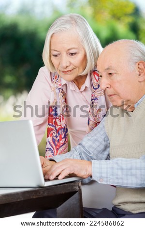 Elderly couple using laptop at nursing home