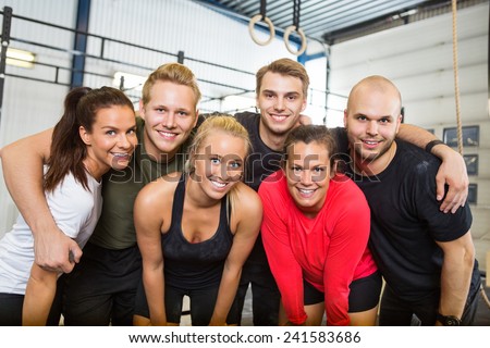 Group portrait of happy people standing together at cross training box