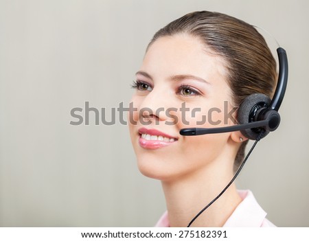 Closeup of customer service representative wearing headphones at office