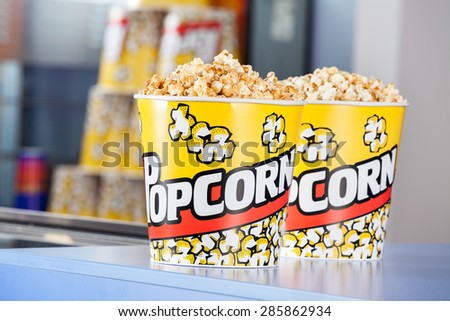 Buckets full of popcorn at concession stand in cinema