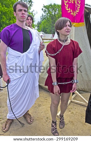 JUNE 6, 2015,  MOSCOW, RUSSIA -  Festival of the historic reconstruction Times and Ages in the park Kolomenskoye. Scene with the young bondmaid and slave-trader