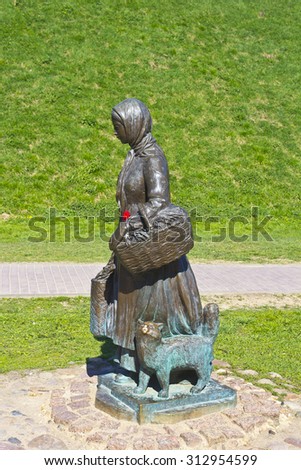 MAY 9, 2014, DMITROV, MOSCOW AREA, RUSSIA - Sculpture of the granger girl with a cat at Kropotkin street.  Kropotkin street is the walking area in central part of the historic town.
