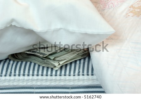A roll of money tucked in a mattress for safekeeping.