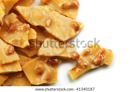 Homemade peanut brittle on a white background
