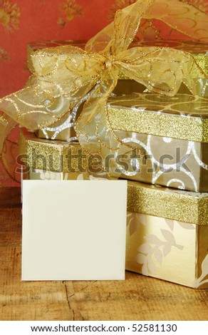 Gift boxes stacked with gold ribbon and gift card blank for your text.