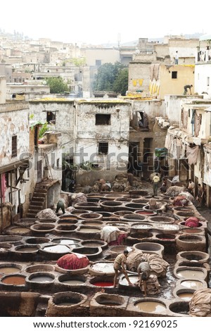 FEZ, MOROCCO - OCTOBER 29: Workers  in the tannery souk of weavers on October 29, 2008 in Fez, Morocco. The tannery souk of weavers is the most visited part of the 2000 years old city.