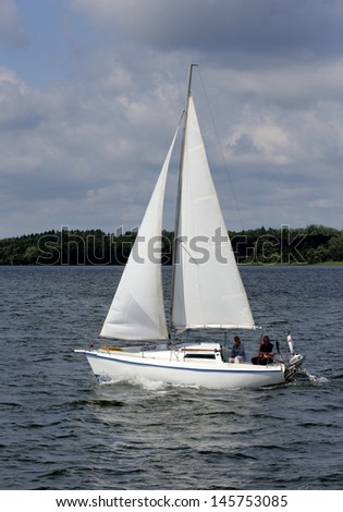MASURIA, POLAND - JULY 13: Unidentified people sailing on Mazury lake on July 13, 2012 in Masurian ditrict, Poland. More than 5 million tourists visit Masuria every year.