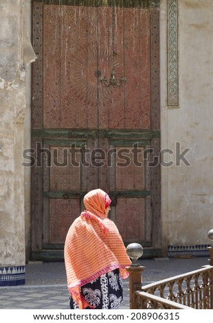 FEZ, MOROCCO - JULY 19: A woman in a souk on July 19, 2014 in Fez, Morocco. The medina is listed as a UNESCO World Heritage Site and is believed to be one of the world\'s largest car-free urban areas.