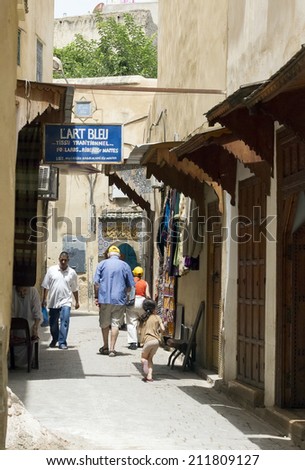 FEZ, MOROCCO - JULY 19: People in a souk on July 19, 2014 in Fez, Morocco. The medina is listed as a UNESCO World Heritage Site and is believed to be one of the world\'s largest car-free urban areas.