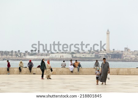 CASABLANCA, MOROCCO - JULY 23: Local people walking on the ramparts near of King Hassan II Mosque on July 23, 2014 in Casablanca, Morocco. It is the largest Mosque in the country
