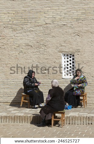 KHIVA, UZBEKISTAN - MARCH 21: Traditionally clouded women posing for tourist  on March 21, 2012 in Khiva, Uzbekistan. Uzbekistan has great potential for an expanded tourism industry.
