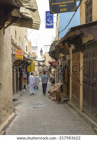 FEZ, MOROCCO - JULY 19: People in a souk on July 19, 2014 in Fez, Morocco. The medina is listed as a UNESCO World Heritage Site and is believed to be one of the world\'s largest car-free urban areas.