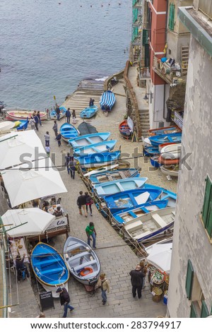 RIO MAGGIORE, ITALY - MAY 5, 2015: Tourist in the port. The village is the first of the Cinque Terre one meets when travelling north from La Spezia, dating from the early thirteenth century.