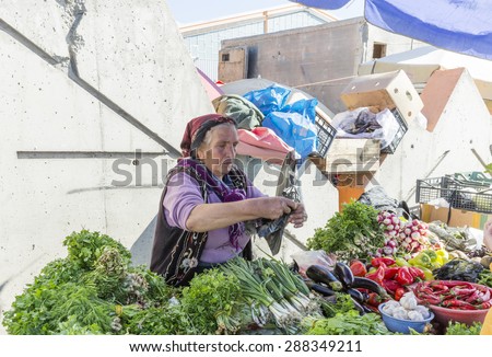 TBILISI, GEORGIA - OCTOBER 22: Woman selling food on the main market on October 22., 2014 in Tbilisi. Tbilisi formerly known as Tiflis, is the capital and the largest city of Georgia