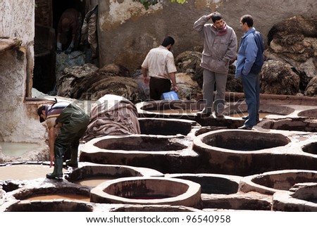 FEZ, MOROCCO - OCTOBER 29: Workers  in the tannery souk of weavers on October 29, 2008 in Fez, Morocco. The tannery souk of weavers is the most visited part of the 2000 years old city.