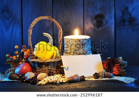 small pumpkin in basket on old weathered wooden floor in blue sunset light