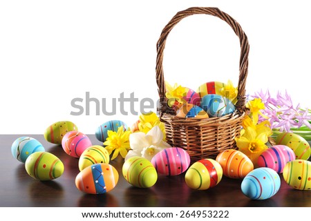 many painted easter eggs with easter basket and hyacinth in front of white background
