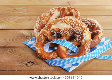 three original bavarian salted soft pretzels from Germany in front of wooden board