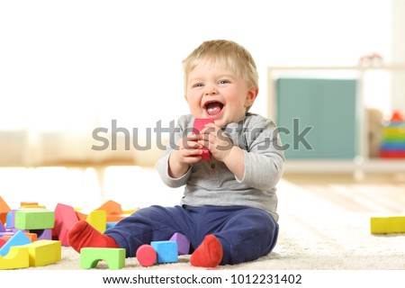 Similar – Image, Stock Photo Baby playing alone with toys on a carpet on the floor at home