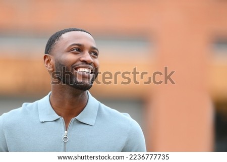 Similar – Image, Stock Photo Handsome Black Man Walking in Park and Listening to Earphones
