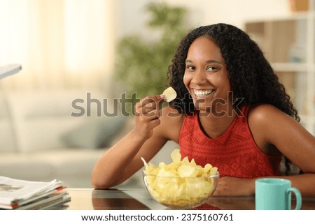 Image, Stock Photo Black woman enjoying fries and burger in restaurant