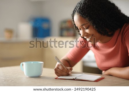 Similar – Image, Stock Photo Ethnic woman taking notes in notebook at home