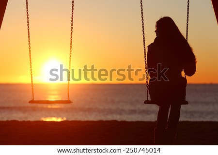 Single woman alone swinging on the beach and looking the other seat missing a boyfriend ストックフォト © 