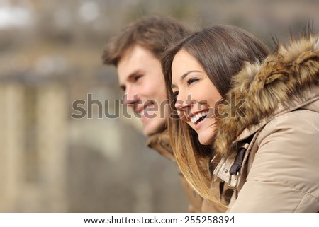 Happy couple profile looking forward in winter holiday