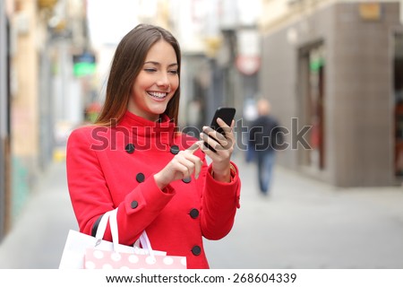 Young woman using public telephone