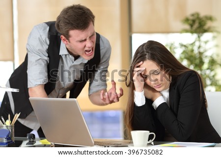 Bullying with an out of control boss shouting to a stressed employee in a desktop at office interior Foto stock © 