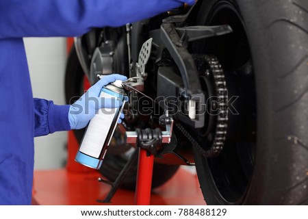 Similar – Image, Stock Photo Technician oiling bike chain in workshop