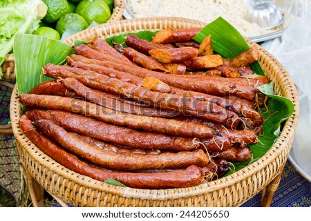Sai Aua (Notrhern Thai Spicy Sausage ) in the market, Nam-Neaung or Northern Thai sausage, Closeup of Thai style grilled sausage on tray with banana leaf,