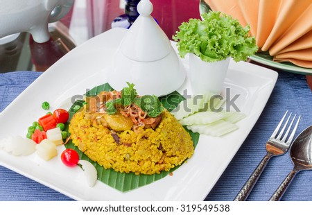 Yellow Rice With Chicken Halal Food Traditional Malayu food or Khao Mok Gai Chicken Biryani thai style.