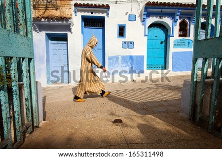 CHEFCHAOUEN, MOROCCO, NOVEMBER 20: person walking on street of the Blue city of Chefchaouen, City is situated in the Rif Mountains in the North of Morocco, 2013